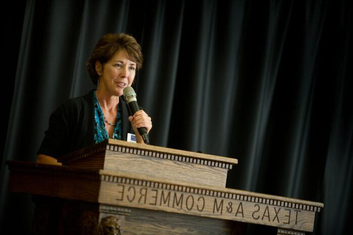 Woman teaching at a social work gala.