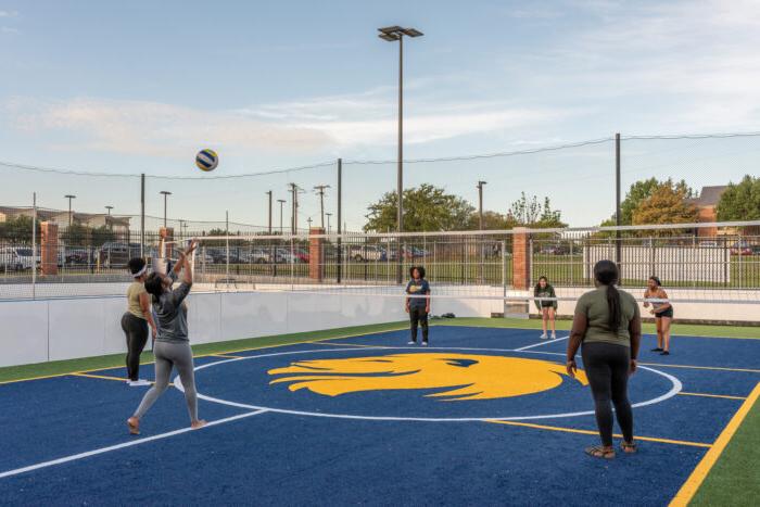 Students playing volleyball at the fields at the Morris Recreation Center.