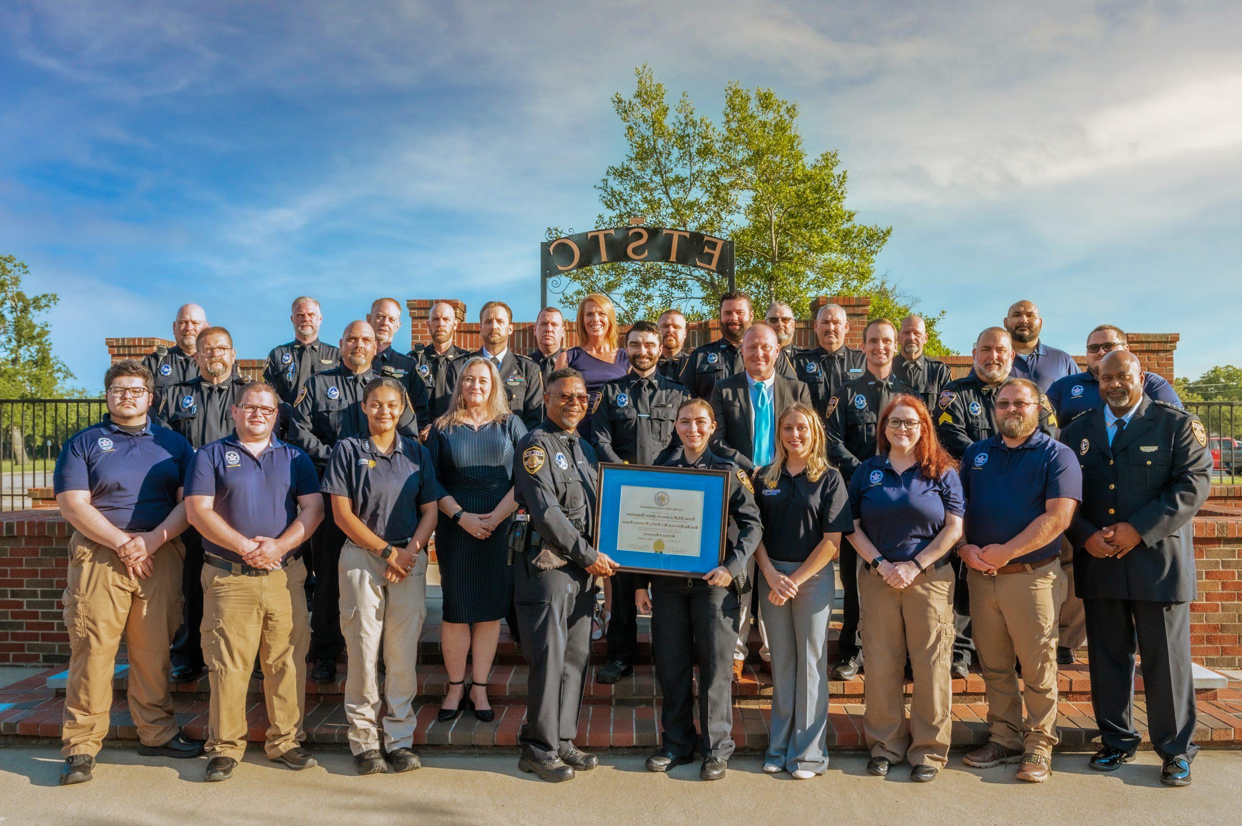 A group of males and female who are a part of the police department.